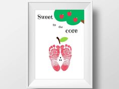 a framed poster with the words sweet to the core and an image of a baby's feet