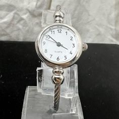 Nwot.Quartz Ladys Watch Has A White Face & A Cable Wrist Holder 18kt. Silver Plating Memory Shape. A Nice Business Watch And Can Be Dressy As Well.Ven30/5 Never Worn. Stainless Steel Round Jewelry And Watches With Metal Dial, Stainless Steel Watch With Adjustable Fit, Adjustable Stainless Steel Watch, White Gold Stainless Steel Watch For Gift, White Gold Stainless Steel Watch As Gift, Gift White Gold Stainless Steel Watch, White Gold Stainless Steel Watch Accessories For Gift, White Gold Stainless Steel Watch Accessories As Gift, Timeless Analog Jewelry For Anniversary