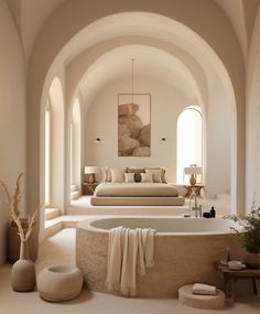 a living room filled with lots of furniture next to a large white bath tub covered in towels