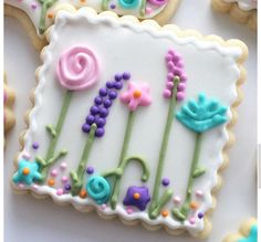 decorated cookies are arranged on a white surface