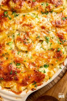 a casserole dish with cheese and parsley on the top is ready to be eaten