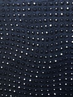 black and white polka dot fabric with small dots on the top, as seen from above