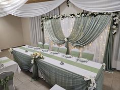 a banquet room set up with green and white decor