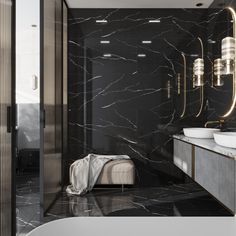 a bathroom with black marble walls and flooring, two sinks on the left side