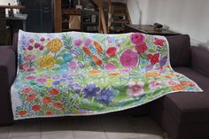 a couch covered with a colorful blanket in a living room