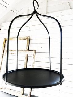 a black birdcage hanging from the ceiling