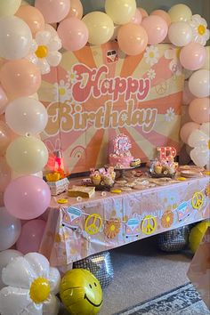 a table topped with lots of balloons and cake