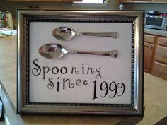 two spoons sitting on top of a sign in a kitchen