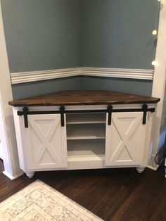 a white entertainment center with sliding doors in a room