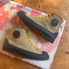 "Hard to tell when these vintage Vasque hiking / climbings are from. They have a 70s look, but could also be 90. Tan suede outer, with thick black rubber vibram soles. Cool yellow laces. These are in excellent condition, ready to wear. These are marked size mens 11.5 with a narrow fit. Please refer the to details and measurements listed below. Label: Vasque Size: 11.5 men's  Outsole Length: 12\" Insole Length: 11.75\" Width: 3.5\" Shaft Height: 6\" All sales final, please review all photos and details prior to purchase" 70s Look, Metallic Sweater, Yellow Lace, Tan Suede, Black Rubber, Work Boots, Boot Shoes Women, Yellow Black, Hiking Boots