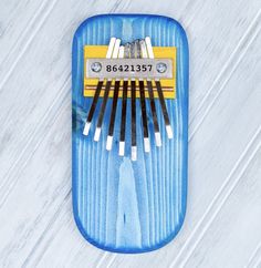 a blue case with six toothbrushes in it on a white surface, top view