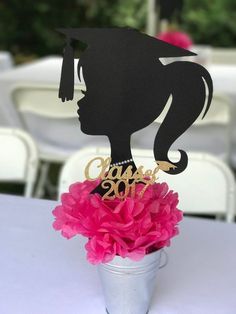 there is a cake topper that has a woman's head on it in a vase