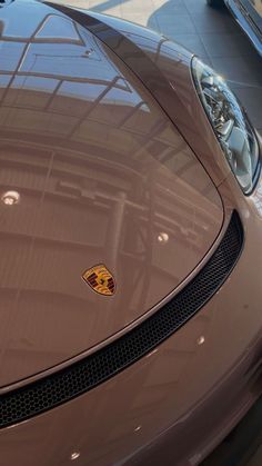 the front end of a brown sports car