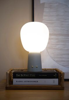 a lamp that is on top of some books