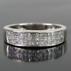 a white gold wedding band with princess cut diamonds