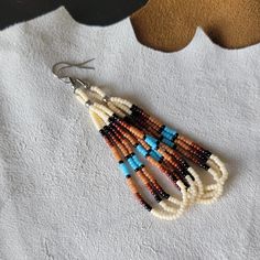 These teardrop beaded earrings are made with stainless steel findings, and three hanging loop strands of Japanese Miyuki and/or Czech beads. Most earrings I make in this style have a pattern in groups of fours or sevens. Four being for the four directions, and seven being for the seven clans of my tribe.  The palette used to make these earrings remind me of Native American Southwestern clay pottery. Colors used in this design: cream, black, dark brown, brown, cedar, and turquoise blue. From top Sarape Pattern, Pottery Colors, Native Earrings, Beaded Earrings Native, Hemp Bracelets, Native American Earrings, Southwest Decor