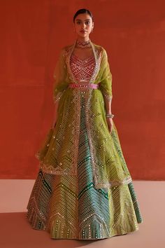 Multi color raw silk lehenga with attached can-can, contrast multi panels, all over chevron pattern gota and mirror embroidery. Paired with contrast V neck embroidered padded blouse and dupatta.
Components: 3
Pattern: Embroidered
Type Of Work: Mirror and Gota Work
Neckline: V Neck
Sleeve Type: Sleeveless
Fabric: Raw Silk, Lining: Crepe
Color: Multi Color
Other Details: 
Embroidered dupatta
Cut work back
Attached lining
Closure:
Lehenga: Side tie-up
Blouse: Back tasselled tie-up, hook and eye
Not Multicolor Gota Work Lehenga For Transitional Season, Multicolor Transitional Lehenga With Gota Work, Multicolor Tissue Silk Set For Navratri, Multicolor Tissue Silk Choli For Reception, Multicolor Tissue Silk Dress With Dupatta, Designer Multicolor Tissue Silk Lehenga, Transitional Green Tissue Silk Lehenga, Festive Multicolor Tissue Silk Dress, Fusion Style Multicolor Lehenga With Cutdana