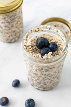 two jars filled with oatmeal and blueberries