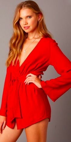 Red Romper. The What If Red Long Sleeve Wrap Romper will make everyone wish they were you! Lightweight fabric in a paprika red hue shapes a plunging neckline wrap bodice that secures around a front tie waist. Attached asymmetric skort and long bell sleeves finish the chic elegant took. Chic V-neck Wrap Top With Tie Waist, Fall V-neck Wrap Top With Tie Waist, Party Top With Tie Waist And V-neck, Chic Surplice Neckline Wrap Top For Night Out, Party V-neck Top With Tie Waist, V-neck Top With Tie Waist For Party, Summer Party V-neck Wrap Top, Spring V-neck Wrap Top In Solid Color, V-neck Wrap Top For Party