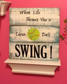 a wooden sign that says when life throws you a curve ball, swing at it