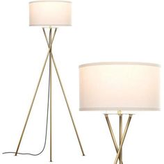 a pair of floor lamps with white shades on each lamp and one light turned off