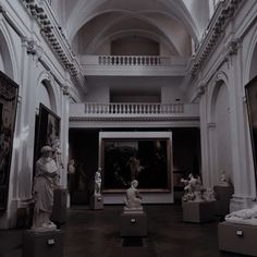 an art gallery with statues and paintings on display in the center, including busturines