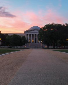 the sun is setting at the lincoln memorial in washington, d c as seen from across the street