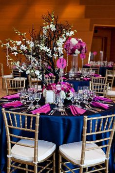 the table is set with purple and white flowers