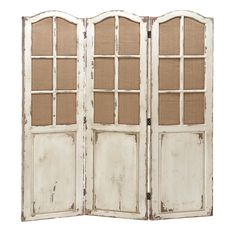 an old white wooden room divider with glass doors on the top and bottom panels