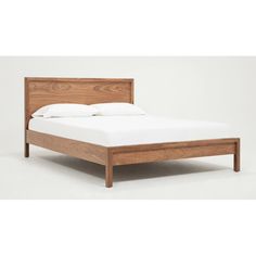 a wooden bed frame with white sheets and pillows on it's headboard, against a plain background