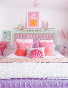 a bedroom with pink and purple decor on the walls