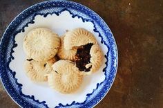 three small pastries on a blue and white plate