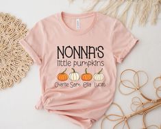 Nonna's Little Pumpkins shirt. This custom Nonna design featuring the grandchildren's names is the perfect shirt for wearing if you are a proud Nonna this fall. Buy it for yourself or give it as the perfect Thanksgiving gift.  Personalized Nonna Fall Shirt, Nonna Halloween Shirt, Nonna Thanksgiving tshirt, Custom Nonna Gifts, Nonnas little pumpkins t-shirt Sizing:  Before ordering please check our size chart (last picture of the listing) for measurements. Available sizes: S, M, L, XL, 2X, 3X (ot Personalized Tops As Fall Gifts, Customizable Pink Tops For Fall, Cricut Shirt Ideas, Nonna Gifts, Grandparents Gifts, Tshirt Custom, Perfect Thanksgiving, Garment Industry, Pumpkin Shirt