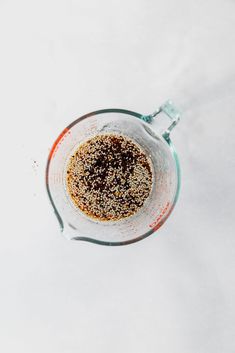 an overhead view of a blender filled with sugar and other ingredients on a white surface