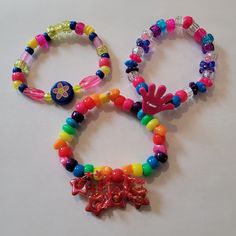 I have been collecting and making kandi since my early rave days in 2000. I will be making special kandi sets that include vintage beads from my collection. Have a little piece of kandi history. I created a playlist on my YouTube channel Kandi Toybox (My kandi bead collection) if you would like to see my collection! These kandi bracelets are made with mostly vintage beads from the 90s,early 2000s and some new beads. New beads are the glitter pony beads. Includes 3 bracelets. Bracelet size 7-8 in Rave Style Colorful Beaded Bracelets For Festival, Rave Style Festival Beaded Bracelets With Colorful Beads, Rave Style Multicolor Beaded Friendship Bracelets, Multicolor Beaded Rave Friendship Bracelets, Rave Style Plastic Jewelry For Festivals, Multicolor Beaded Friendship Bracelets For Rave, Colorful Beaded Rave Jewelry, Multicolor Rave Jewelry For Party, Rainbow Rave Jewelry With Colorful Beads