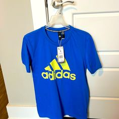 Royal Blue With Yellow Writing Adidas, Short Sleeve Men’s T-Shirt Sports Shirt With Blue Logo Print, Blue Sports Shirt With Graphic Print, Blue Graphic Print Sports Shirt, Blue Sports T-shirt With Logo Print, Adidas Blue Sporty Shirt, Sporty Adidas Blue Shirt, Blue Short Sleeve Shirt With Logo Print, Blue Moisture-wicking Graphic Tee, Blue Graphic Tee For Sports