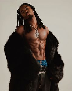 a shirtless man with dreadlocks and no shirt standing in front of a white background