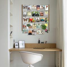 a wooden desk topped with a white chair next to a wall covered in pictures and magnets