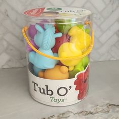 tub o'toys in a plastic container on a marble counter with tile back splash