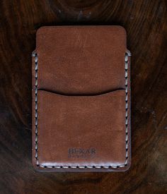 DESCRIPTION The Simple Card Wallet is one of our most simple wallets. It features two pockets, one main pocket for card storage, and one quick access pocket. The Simple Card Wallet is saddle stitched by hand, joining each leather piece together with a durable poly cord thread. The saddle stitch technique has been favored for centuries by expert leather workers, and has a distinct durability advantage when compared to the lock stitch technique produced by machine stitching. If you like to keep th Simple Wallet, Saddle Stitch, Card Storage, Leather Pieces, Simple Cards, Card Wallet, Saddle, Wallets, Card Holder