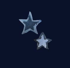 two silver stars on a black background, one is larger and the other is smaller