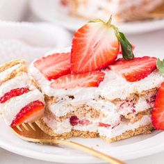 there is a piece of cake with strawberries on it and a fork next to it