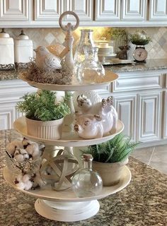 three tiered trays filled with dishes on top of a kitchen counter