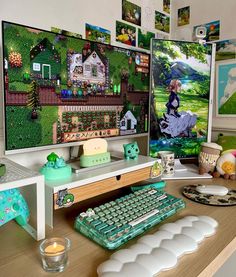 a desk with a keyboard, monitor and pictures on the wall