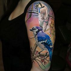 a woman with a blue jay tattoo on her arm