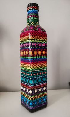 a colorful vase is sitting on a table