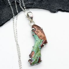 "The necklace is made with an amazing polished sliced freeform chunk of gorgeous natural copper with natural vibrant teal patina wrapped in a sterling silver bezel. The copper piece is 1/2\" x 1 1/2\", and is 1 7/8'\" long with the sterling silver bail . This amazing pendant hangs from a shiny 18\" 1.5 mm sterling silver necklace with a sterling silver spring ring clasp. A very beautiful necklace! You will receive the necklace in a gift box with a jewelry tags stating gemstones and metals used." Unique Green Patina Necklaces, Unique Turquoise Copper Necklaces, Unique Turquoise Copper Necklace, Silver Copper Collectible Necklaces, Unique Silver Necklace With Patina, Unique Turquoise Necklace With Patina For Gift, Turquoise Copper Necklace With Patina, Unique Freeform Copper Necklace, Unique Pendant Necklace With Patina