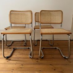 two chairs sitting next to each other on a hard wood floor