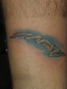 a man with a tattoo on his leg that has a woman's body in the shape of a wave