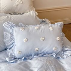 a bed with blue sheets and pillows on it